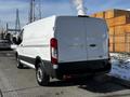 A white 2018 Ford Transit van with a cargo area in the rear and black accents on the bumper and sides