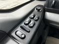 Close-up of the control panel for power windows and locks featuring various buttons and a knob on the armrest of a 2007 Ford F-550