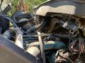 Engine compartment of a 2007 International 7300 showing various pipes wires and components including a turbocharger and an air intake system