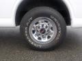 A close-up of a chrome wheel with a GMC logo attached to a 2011 Chevrolet Express showcasing a Uniroyal tire with light tread pattern