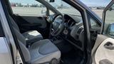 Interior view of a 2006 Honda Fit showing two front seats and the steering wheel with dashboard controls