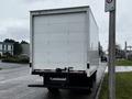 A white 2021 Mitsubishi FE box truck parked on the street with a plain rear view and no visible markings or logos