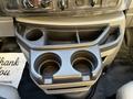 Interior view of a 2017 Ford Econoline showing the center console with two cup holders and additional storage compartments