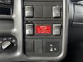 Control panel of a 2006 GMC C5000 featuring various buttons and a warning label regarding engine and power take-off settings