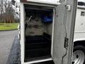 Open compartment of a 2009 Ford F-550 with shelves and storage space visible inside