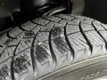 Close-up of a tire tread from a 2014 Ford F-150 showcasing deep grooves and texture for traction