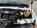 Close-up of the engine compartment of a 2004 Ford Econoline showing the air intake manifold radiator overflow tank and various engine components