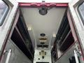 Interior view of a 1994 Freightliner FL80 showing the ceiling with lights and compartments above the cargo area