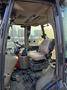 Interior view of a 2015 Case 590SN construction vehicle showing the driver's seat and control panel