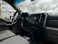 Interior view of a 2017 Ford F-550 featuring a steering wheel dashboard and seats in gray fabric with controls and a display screen visible