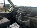 Interior of a 2020 Ford Transit featuring a steering wheel dashboard control panel and gear shifter