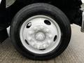 Close-up view of a white wheel and tire from a 2013 Ford F-650 showcasing multiple lug nuts and a tire with the brand name Marathon R3S