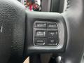 A close-up of the steering wheel controls of a 2022 RAM 1500 Classic featuring buttons for gear selection and cruise control settings