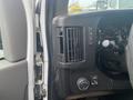 Interior view of a 2012 Chevrolet Express dashboard showing the air conditioning vents control knobs and a portion of the steering wheel