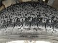 Close-up of a tire from a 2016 Ford F-150 showing detailed tread pattern and moisture on the surface