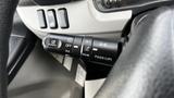 Close-up of the steering wheel controls for cruise control in a 2018 Mitsubishi Fuso FE showing buttons for cancel, off, set, auto, and pass up