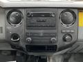Dashboard of a 2013 Ford F-650 featuring a radio, climate control buttons, and various controls