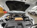 The image shows the engine compartment of a 2016 Ford F-150 with the hood raised revealing various components including the engine block and battery