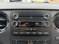 Dashboard of a 2011 Ford F-550 with audio controls and display showing the time as 7:02