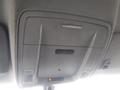 Interior overhead console of a 2015 Chevrolet Silverado 1500 featuring light controls and an indicator light