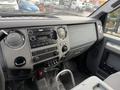 Interior dashboard of a 2013 Ford F-350 SD featuring a radio and climate control dials with the words SUPER DUTY prominently displayed