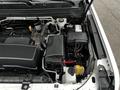 The image shows the engine compartment of a 2018 Chevrolet Colorado with visible components like the battery fluid reservoir and various connected wires and hoses