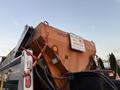 A 2006 Freightliner M2 106 snowplow truck with an orange plow attached and a caution sign indicating not to pass the snowplow