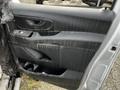 A 2018 Mercedes-Benz Metris driver's side door panel showing worn and dirty black plastic trim with a handle and window controls