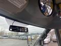 Interior view of a 2017 Chevrolet Express showing the dashboard with a rearview mirror and a curved mirror for visibility