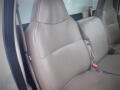 Interior view of a 2008 Ford F-550 with two front leather seats in light beige facing forward