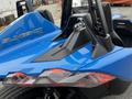 A blue 2020 Polaris Slingshot highlighting its sleek design with distinct rear lights and a sporty seating area