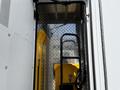 A 2013 Chevrolet Express van with open doors revealing a yellow hand truck inside and a diamond plate flooring surface