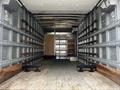 A 2018 Hino 195 truck with an empty cargo area featuring metal walls wooden rails and a wooden panel in the back