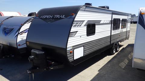 2022 Aspen Trail travel trailer with a sleek black and silver exterior featuring a streamlined design and dual axles