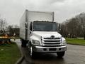 A white 2020 Hino 338 box truck with a silver front grille and orange reflective markers on the roof