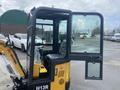 2024 AGT Industrial H13R Mini Excavator with an open cabin door revealing controls and seating inside the operator area