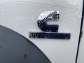 Close-up of a chrome badge on a 2008 Dodge Ram 5500 displaying the text Cummins Turbo Diesel with water droplets on the surface