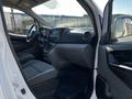 Interior view of a 2017 Nissan NV200 showing the dashboard seats and steering wheel