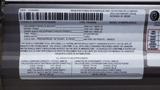 A label with specifications for a 2022 Aspen Trail RV including vehicle weight gross vehicle weight rating and cargo carrying capacity
