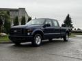 2008 Ford F-250 SD in dark blue color with a crew cab and chrome wheels parked on a paved surface