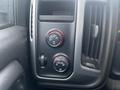 Controls and knobs for temperature and lighting on the dashboard of a 2015 GMC Sierra 1500