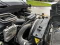 Close-up of the engine compartment of a 2011 International DuraStar 4300 showing various mechanical components and hoses