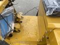 A close-up view of the control panel and seat of a yellow 2024 AGT KRW 23 Mini loader with visible operating levers and protective covering on the seat