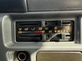 Dashboard controls of a 2007 GMC W5500 18 Foot Cube Van featuring temperature settings with blue and red markings for cool and hot along with air conditioning options