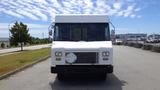 A white 2011 Ford Econoline vehicle with a flat front and large windshield featuring side mirrors and a blank sign panel on the front