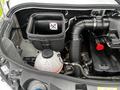 A 2021 Mercedes-Benz Sprinter engine compartment showing the air filter housing with a warning symbol and connected hoses and fluid reservoirs