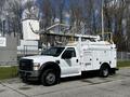 A white 2008 Ford F-550 bucket truck equipped with a ladder and storage compartments on the side