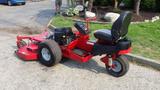 A red 2014 Ferris Mower ISX 800 featuring a seat on a compact frame with a large cutting deck and two rear wheels designed for lawn maintenance