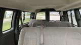 Interior view of a 2017 Chevrolet Express Quigley 4x4 showing multiple rows of gray upholstered seating with seatbelts