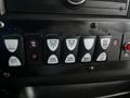 Dashboard controls of a 2017 Chevrolet Express featuring various buttons for lights and doors